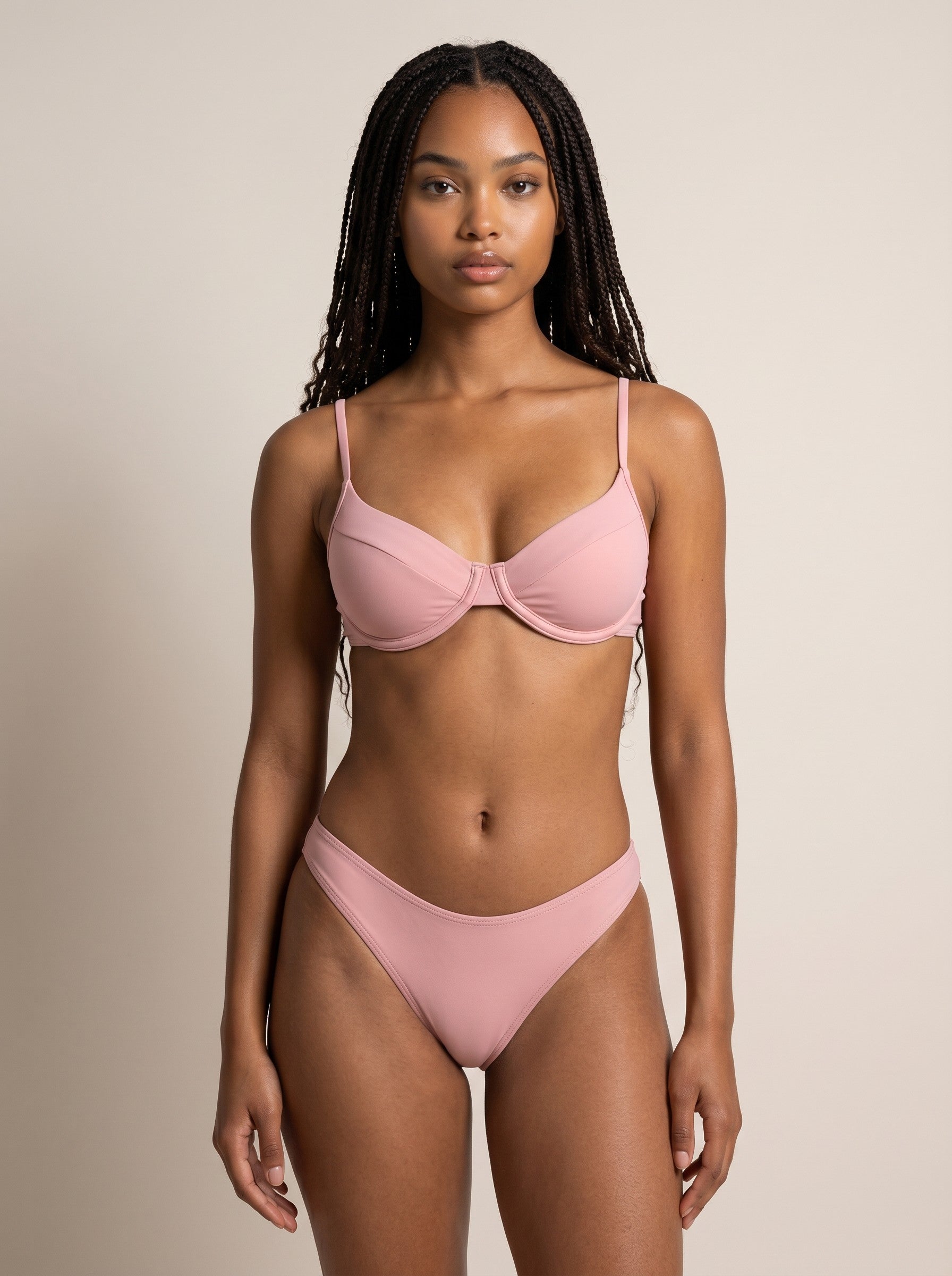 Woman wearing a pink bikini against a beige background